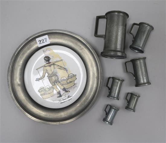 A set of 6 French pewter measures and a pewter plate Tallest 11cm